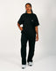 Person wearing a black t-shirt and black pants on a white background