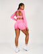 Person wearing a pink athletic outfit on a white background
