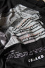 Black t-shirt with printed text and graphics, including 'BAAKD' branding.
